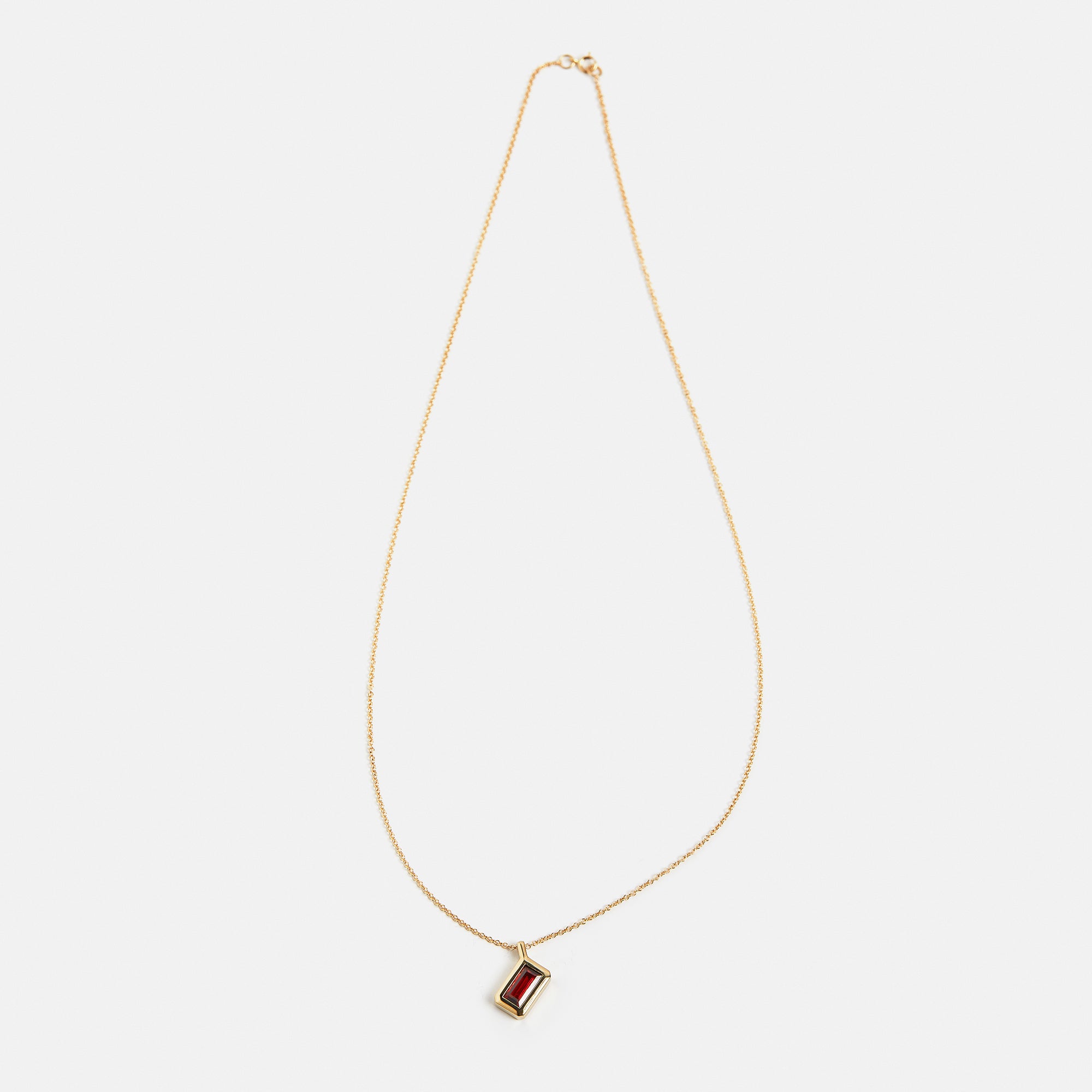 Minimalist necklace with dainty chain and dark red garnet pendant in 14k 18k gold by SHW famous fine jewelry stores in NYC East Village