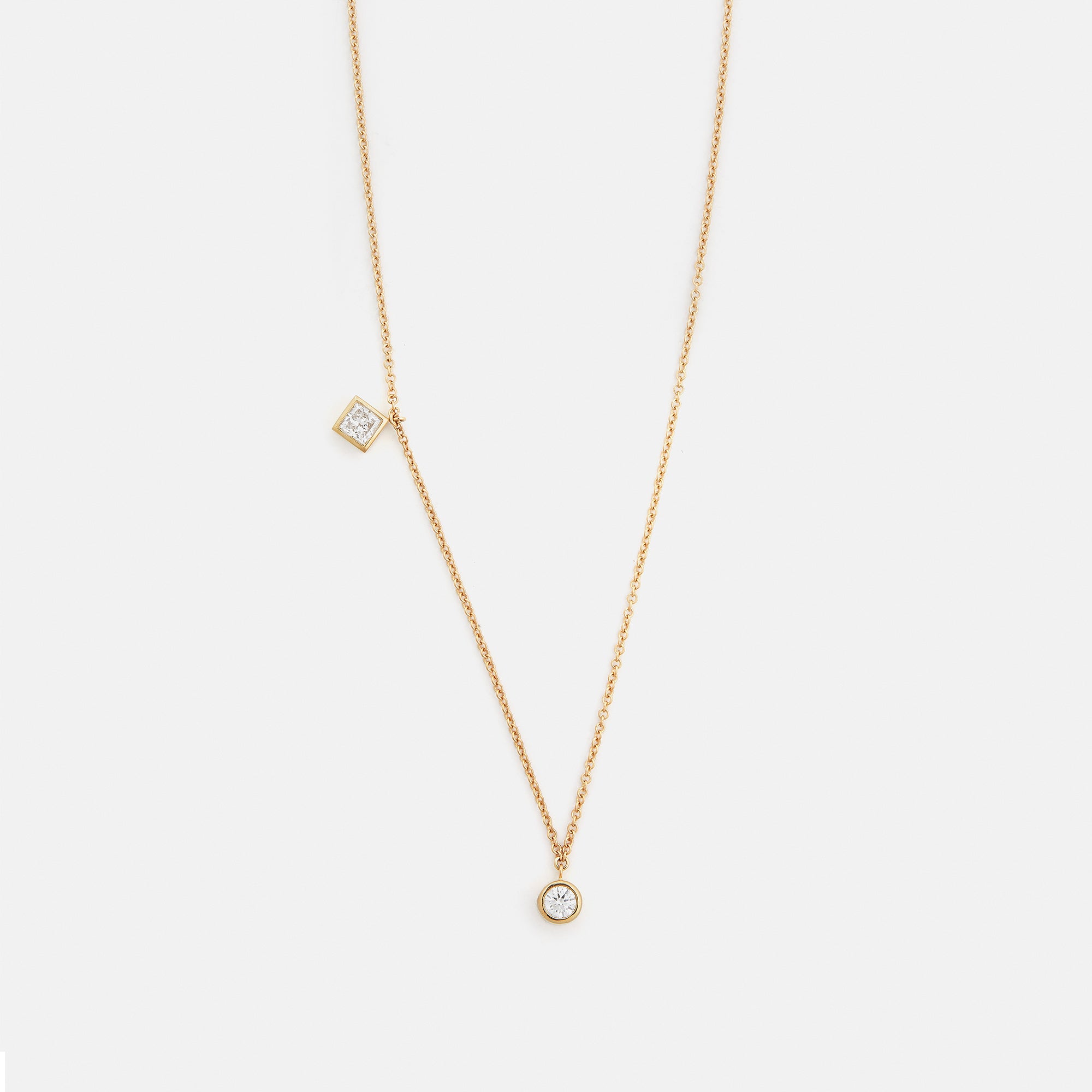 Asymmetrical delicate 18 inch chain necklace with two princess cut and round lab white diamonds in 14k gold by SHW fine jewelry stores NYC