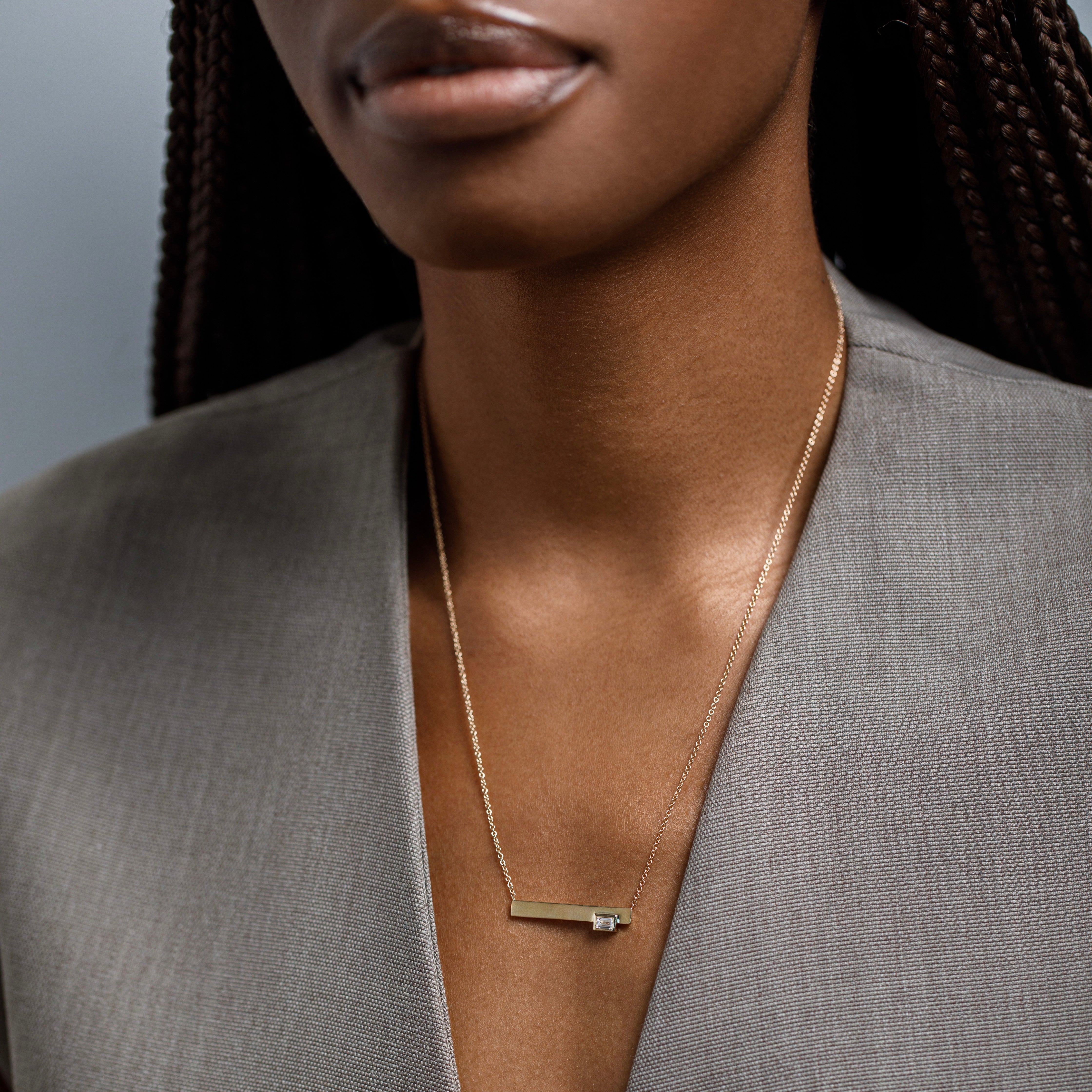 Minimal chain necklace with asymmetrical pendant with lab made baguette cut white diamond in 14k gold by SHW best fine jewelry store in NYC