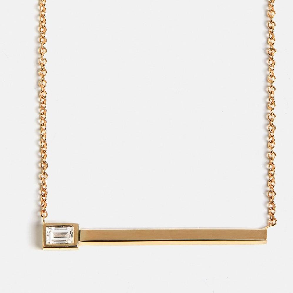 Alternative necklace with delicate chain and asymmetrical pendant with lab created baguette white diamond in 14 karat gold by SHW fine jewelry NYC