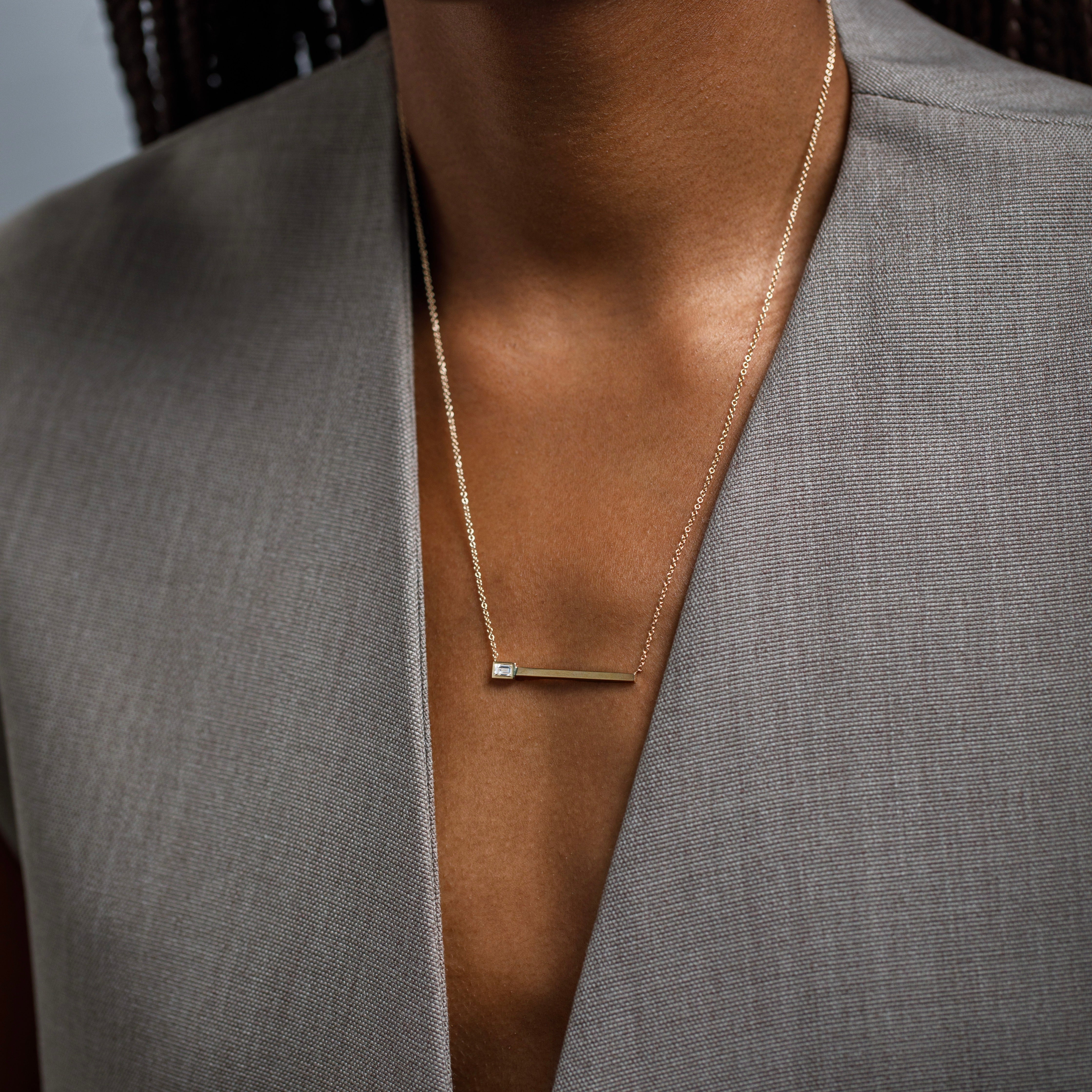 Unusual necklace with asymmetrical pendant with lab made baguette cut white diamond in 14k gold by SHW best fine jewelry store in NYC