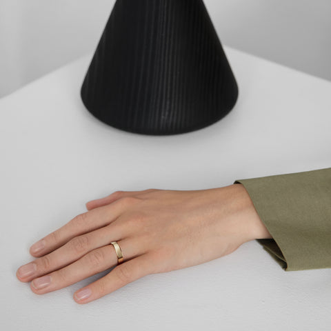 5mm flat and domed wedding band displayed on hand