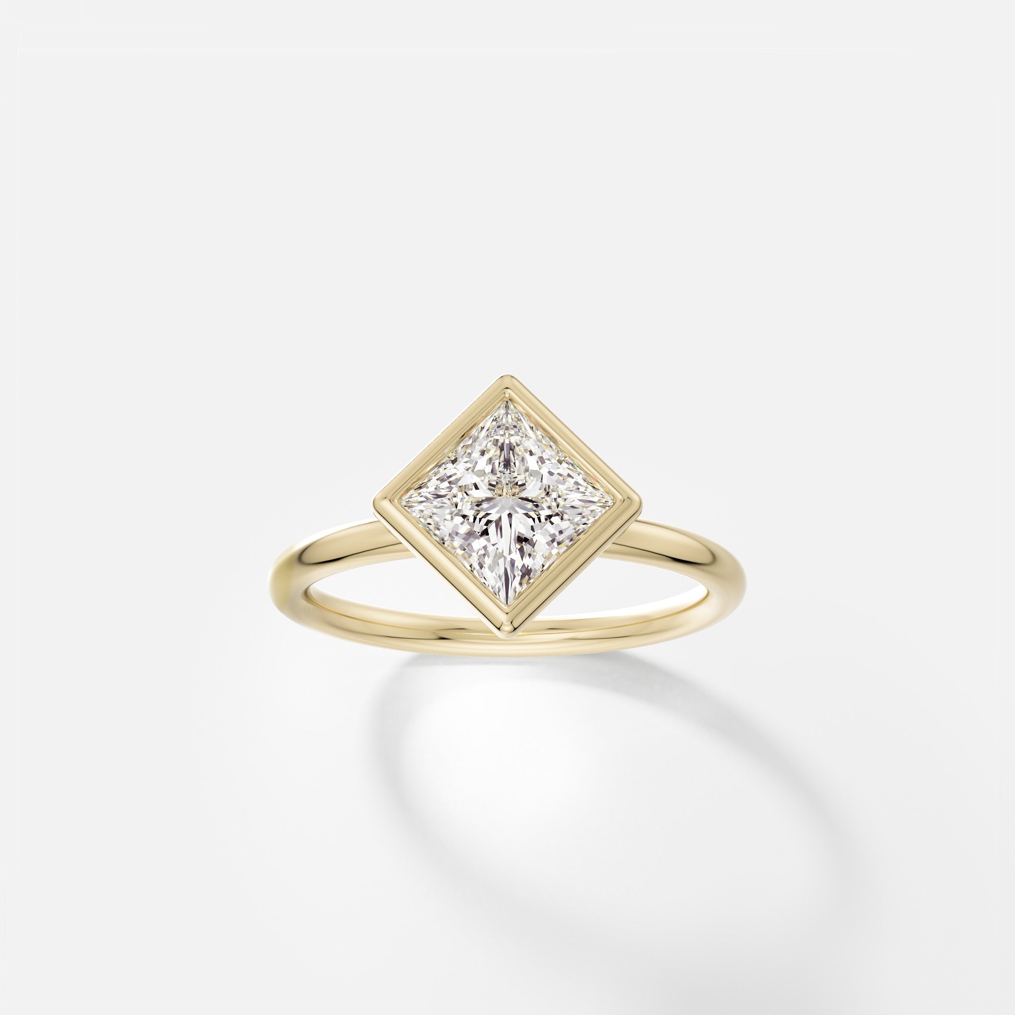 14k yellow gold engagement ring with 1.50 carat tilted princess-cut diamond in thin bezel on delicate round band