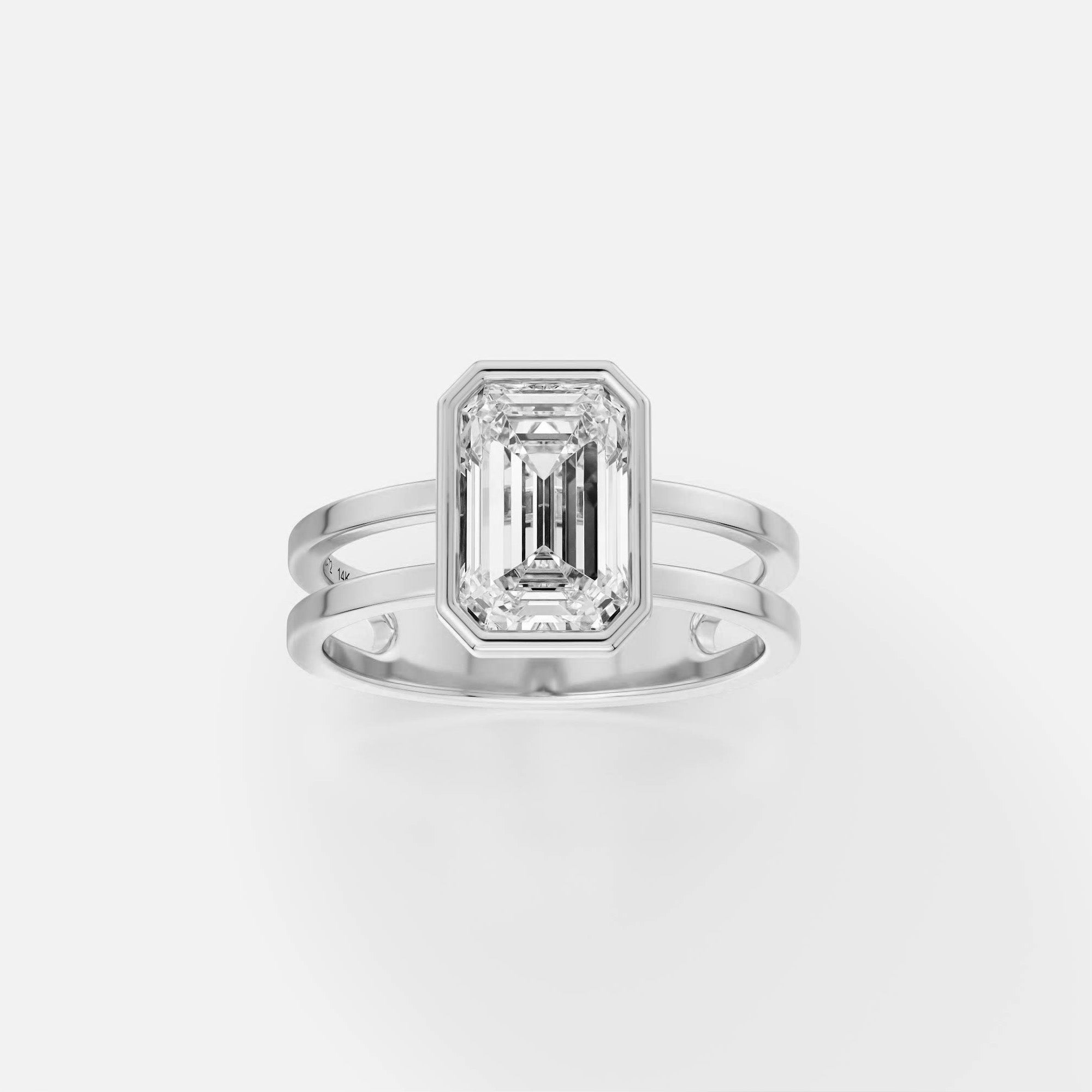 Platinum double band engagement ring with 2 carat emerald-cut diamond in thin bezel setting