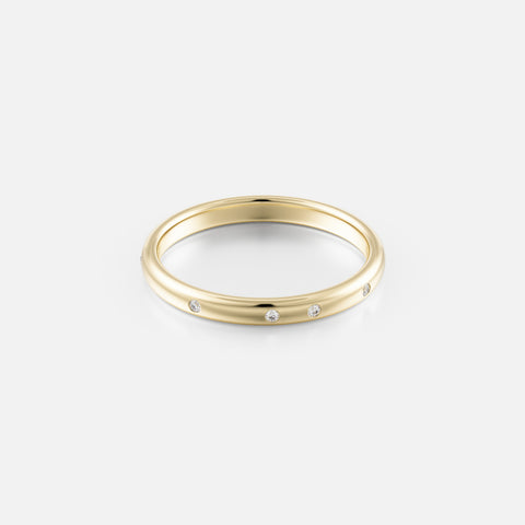 14k yellow gold wedding band with irregularly spaced round diamonds