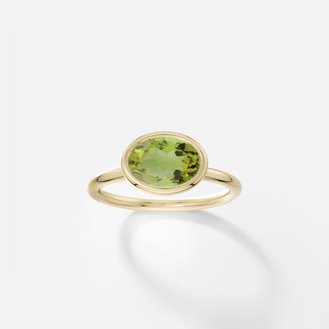 Oval peridot ring with east-west bezel setting, thin round band in solid 14k gold by SHW fine jewelry NYC