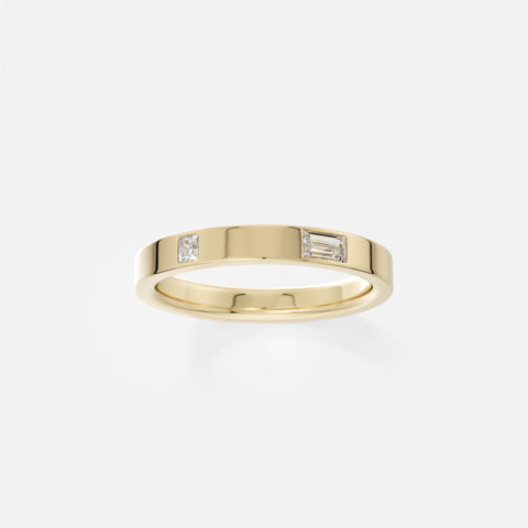 14k yellow gold flat profile band with one baguette and one princess-cut diamond