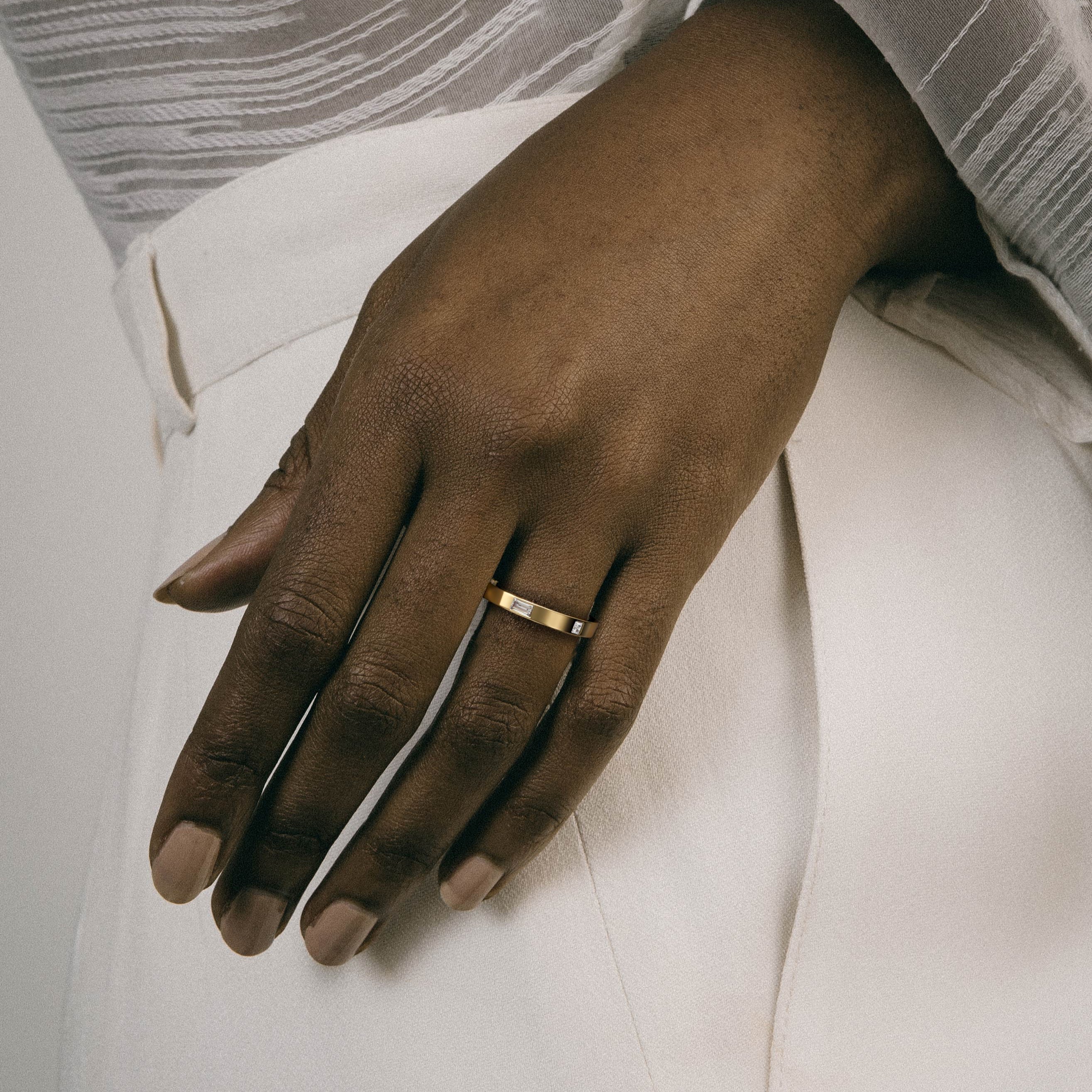 Flat gold diamond band worn on hand