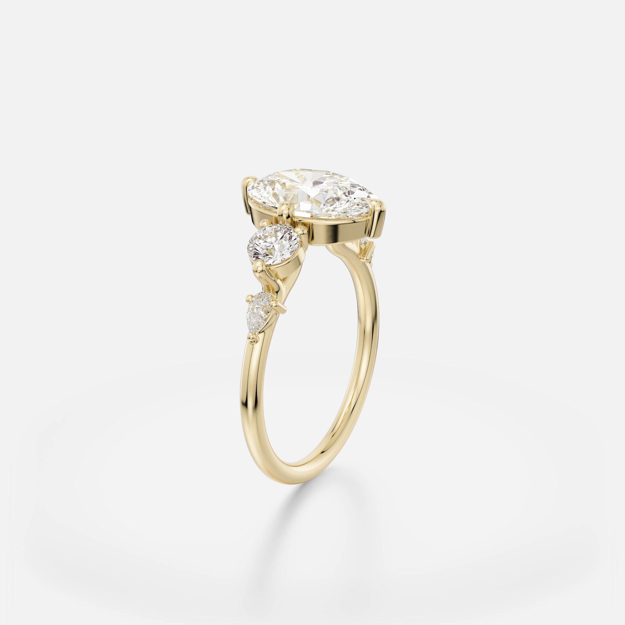 2.50 carat oval diamond engagement ring with round and pear accent stones in five stone cluster prong setting