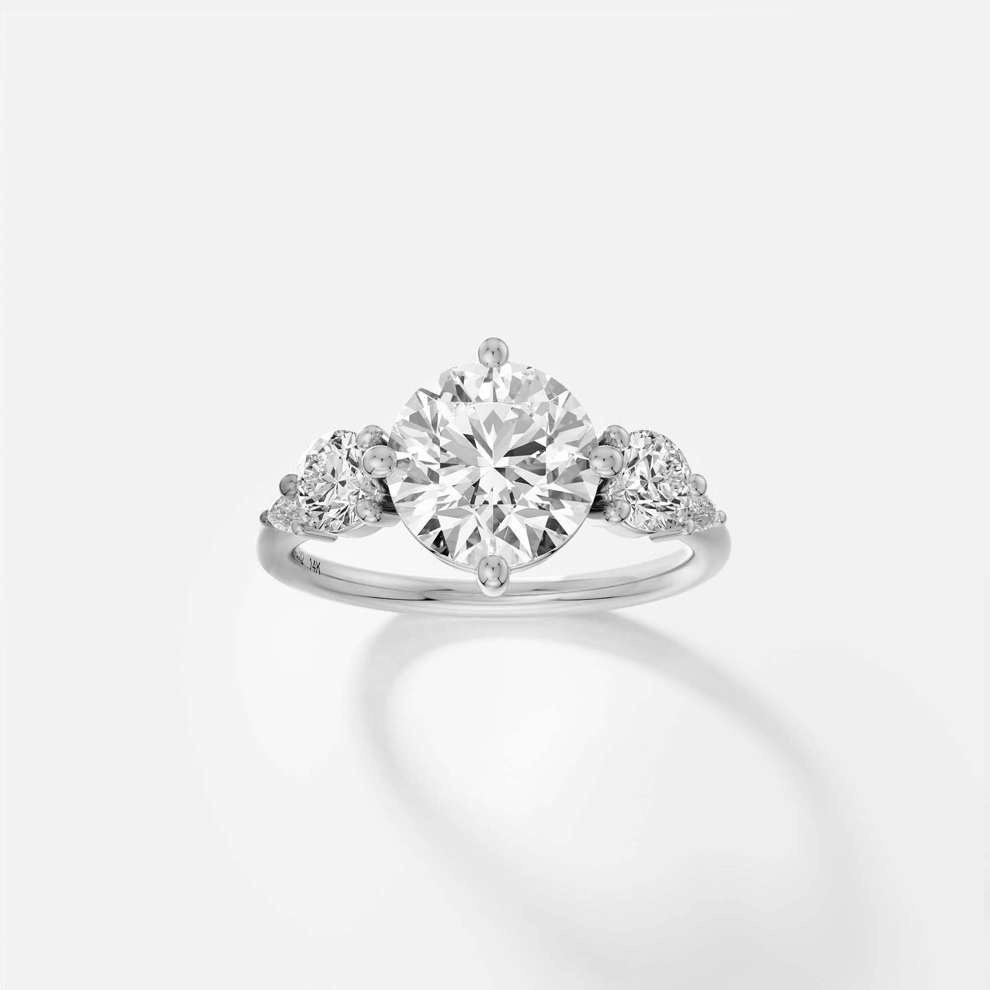 platinum five stone engagement ring with 2.50 carat round brilliant diamond and pear and round side stones on delicate band
