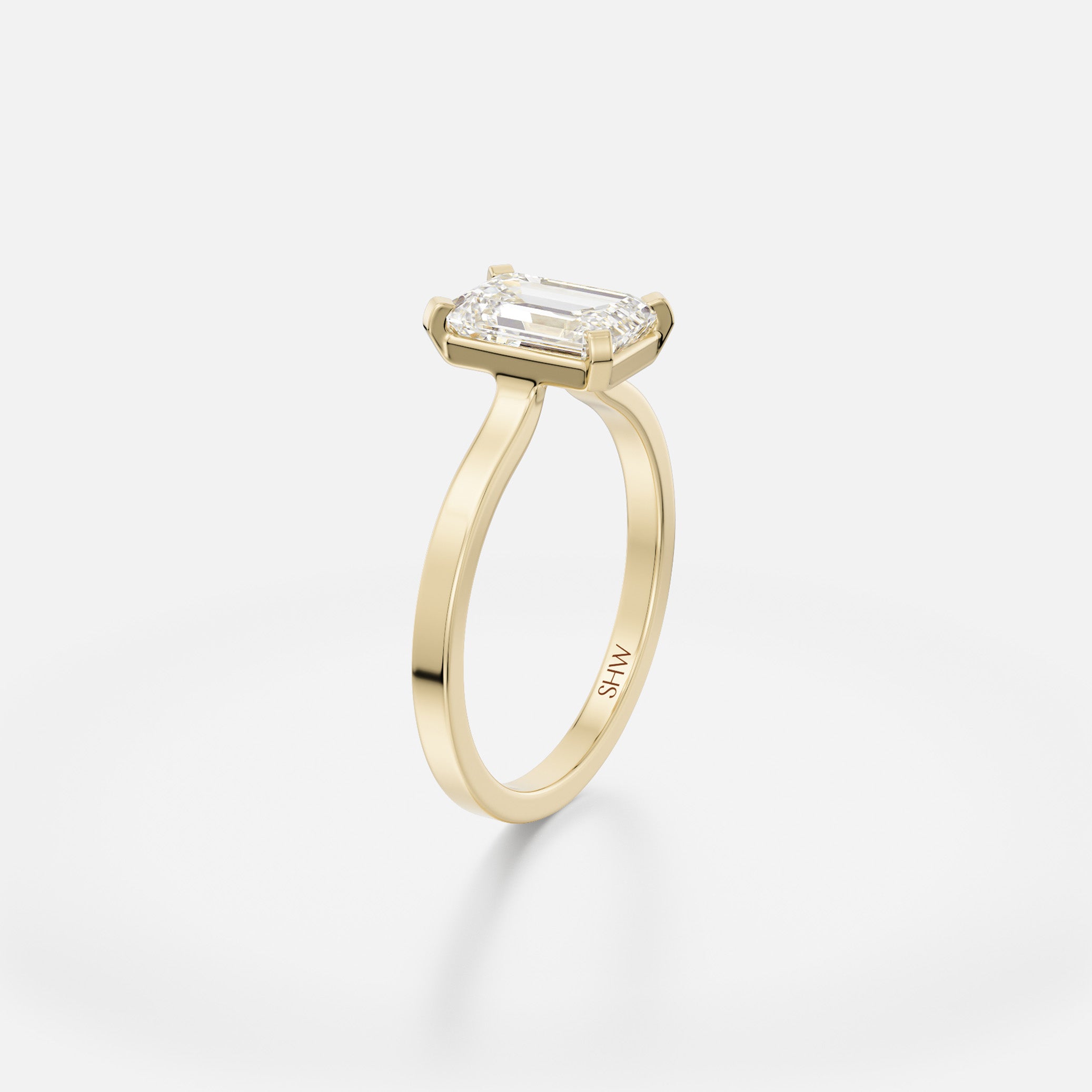 Delicate flat profile ring with open setting holding 1.5 ct emerald-cut step-cut diamond