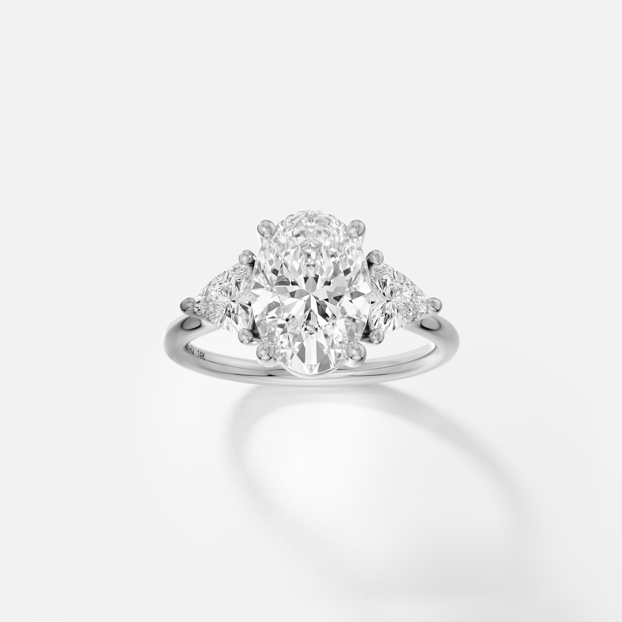 platinum engagement ring with 2.50 carat oval diamond and trillion side diamonds on delicate band