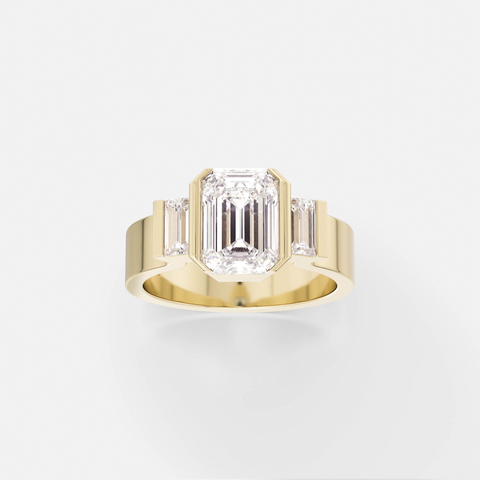 14k yellow gold engagement ring with north-south emerald-cut diamond and baguette side stones in partial bezel setting on flat profile band