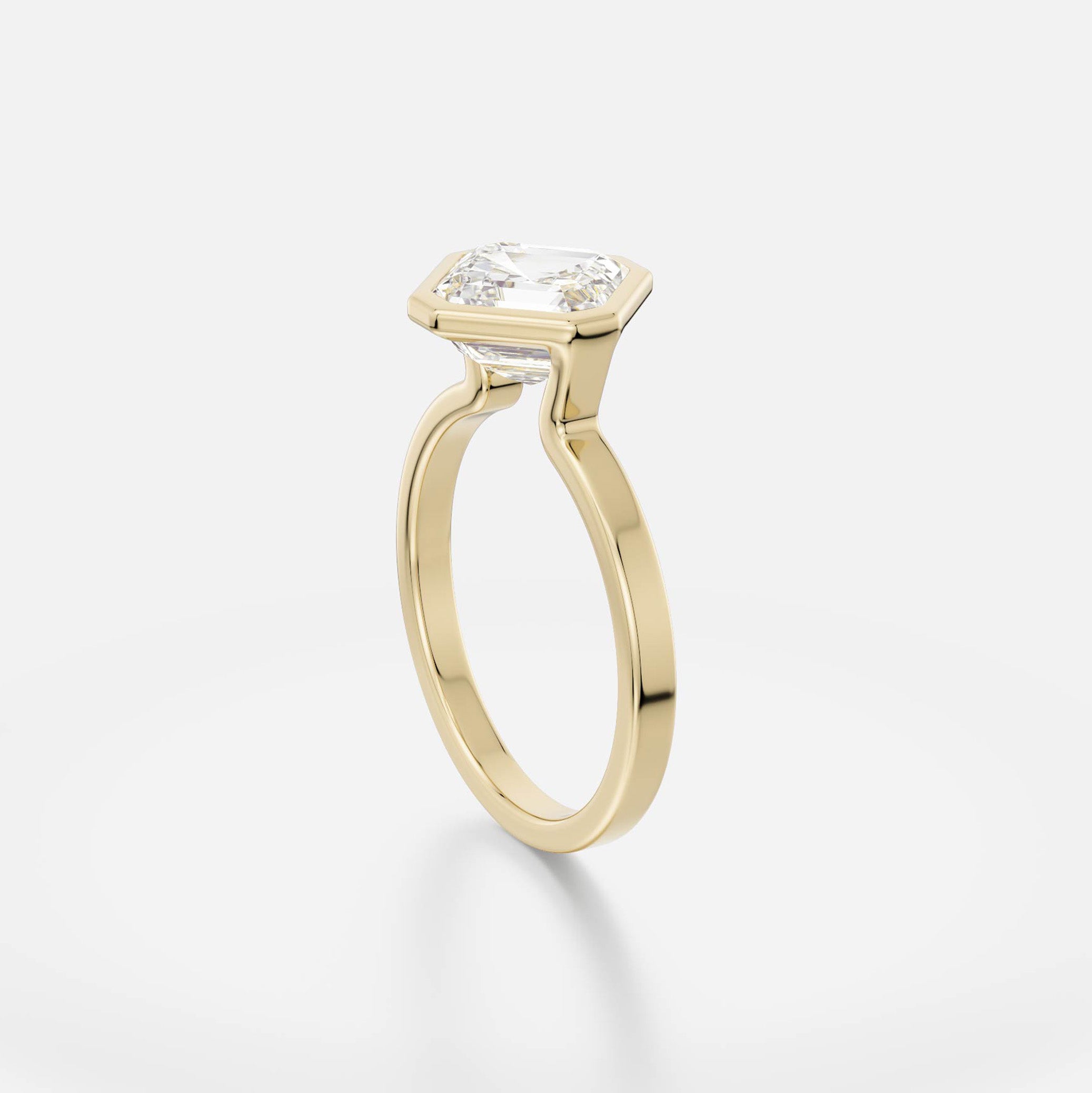 14 karat yellow gold engagement ring with tilted asscher diamond in minimalist bezel setting on flat profile band