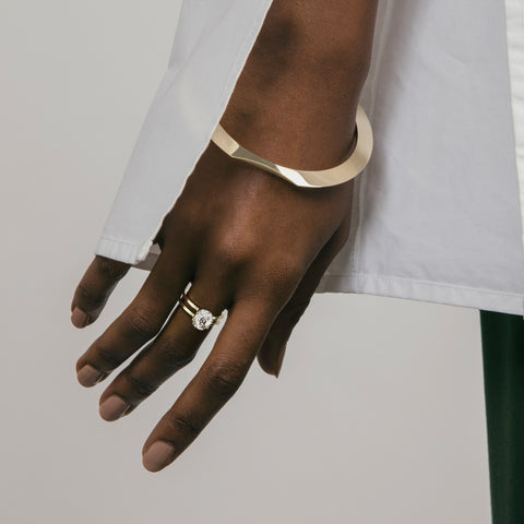 Modern double band engagement ring with cushion diamond worn on hand