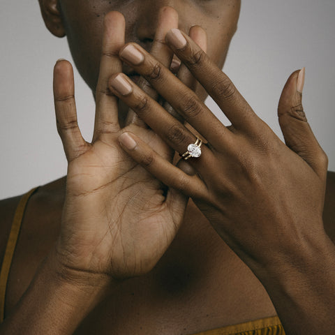 Modern double band engagement ring with oval diamond worn on hand