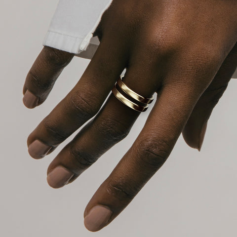 Minimalist double band wedding ring shown worn in natural light