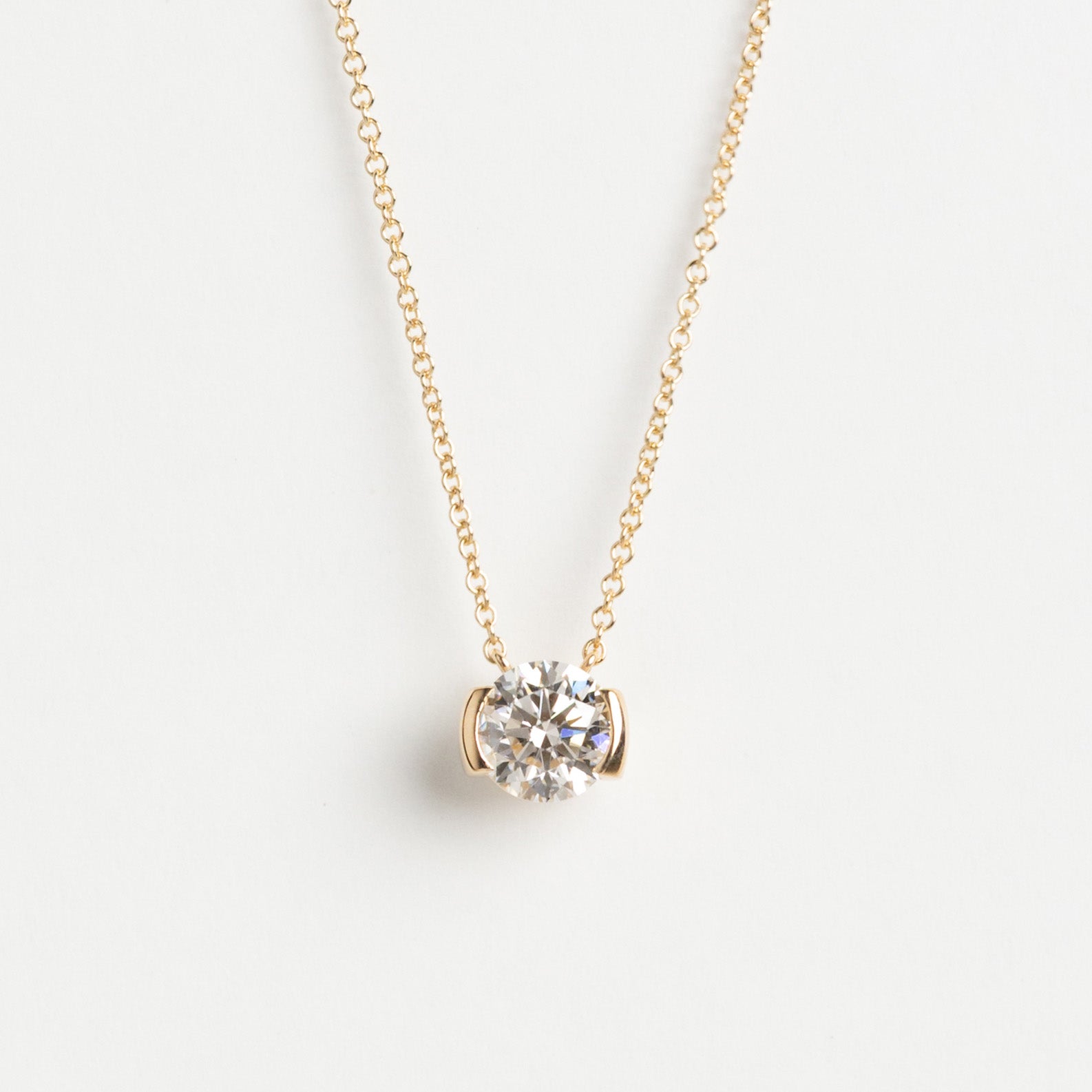 Round lab-grown diamond half-bezel necklace in 14k yellow gold