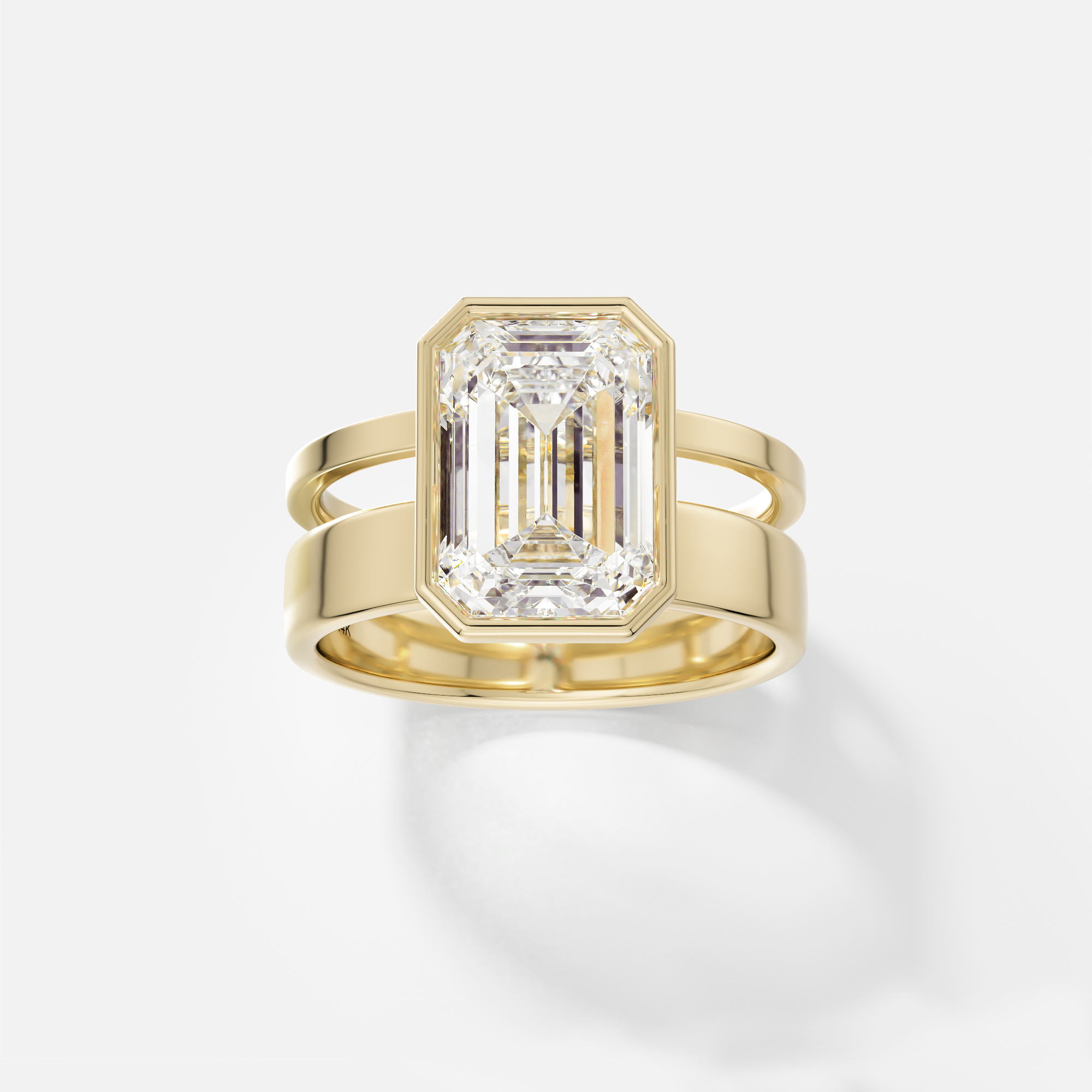 14k yellow gold engagement ring with 4.00 carat emerald-cut diamond in bezel setting on sculptural double band design
