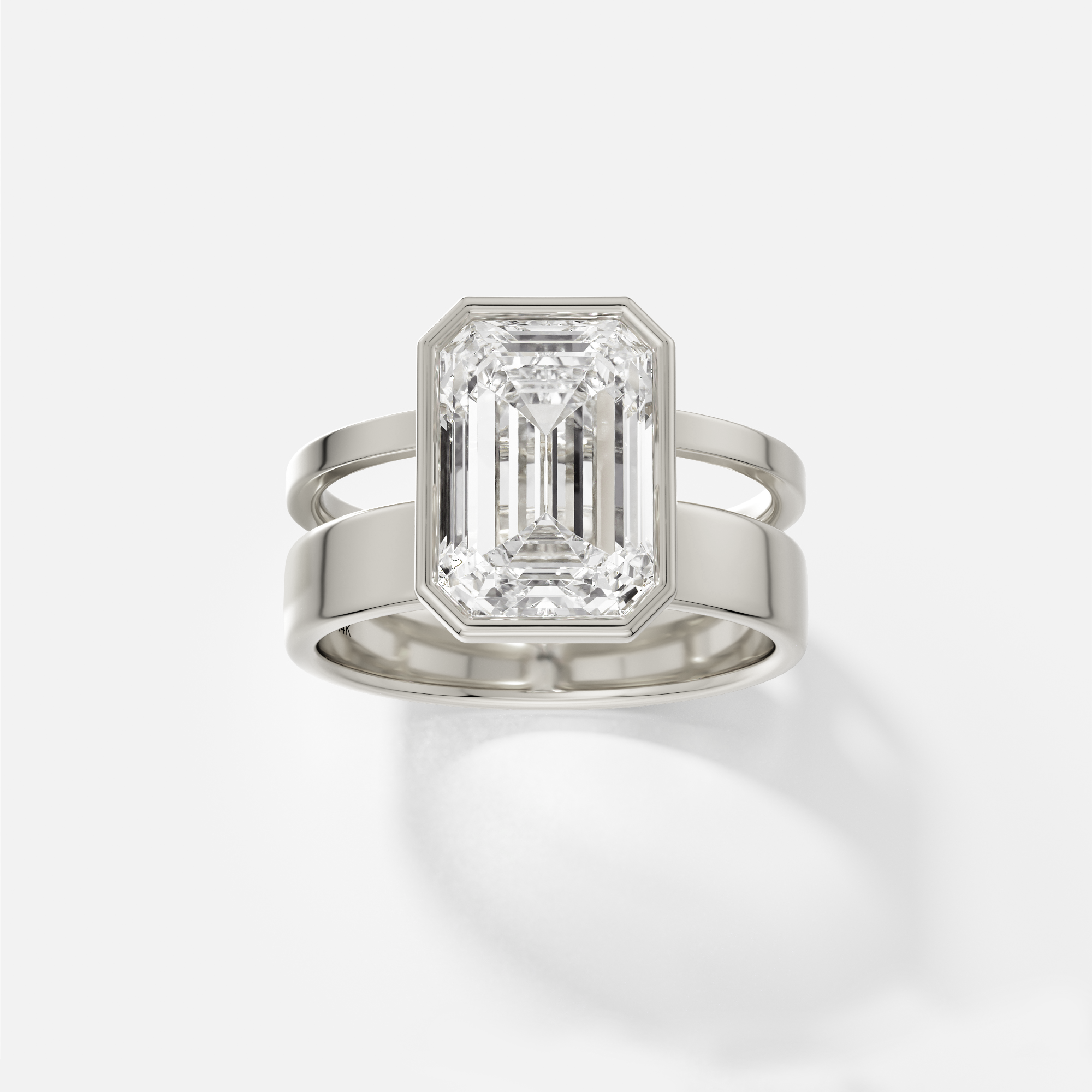 14k white gold engagement ring with 4.00 ct emerald-cut diamond in bezel setting on modern double band