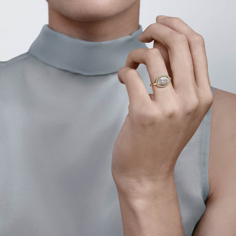 Close view of oval diamond halo engagement ring with pavé diamond halo on slim band