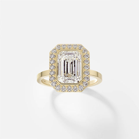 14k yellow gold halo engagement ring with 2.50 carat emerald-cut diamond in bezel halo with pavé diamond surround