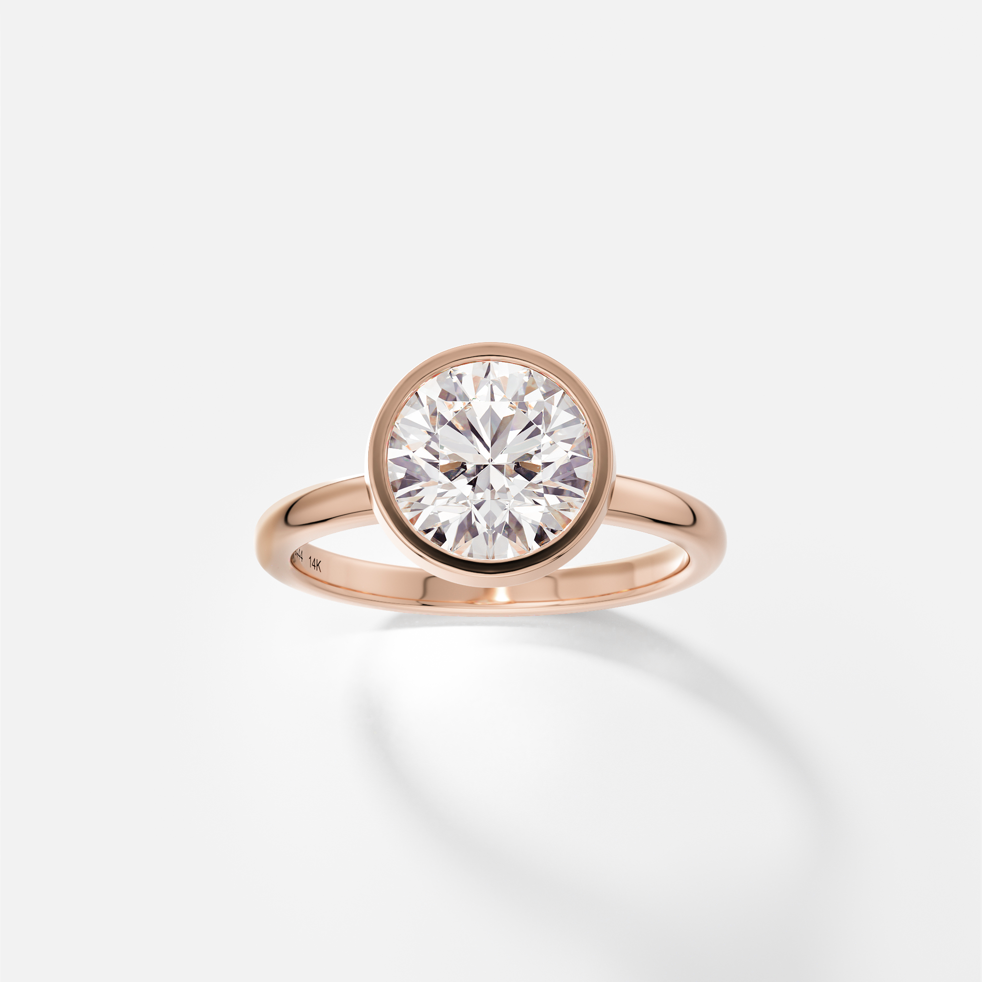 Syd round brilliant diamond bezel engagement ring front view in 14k rose gold
