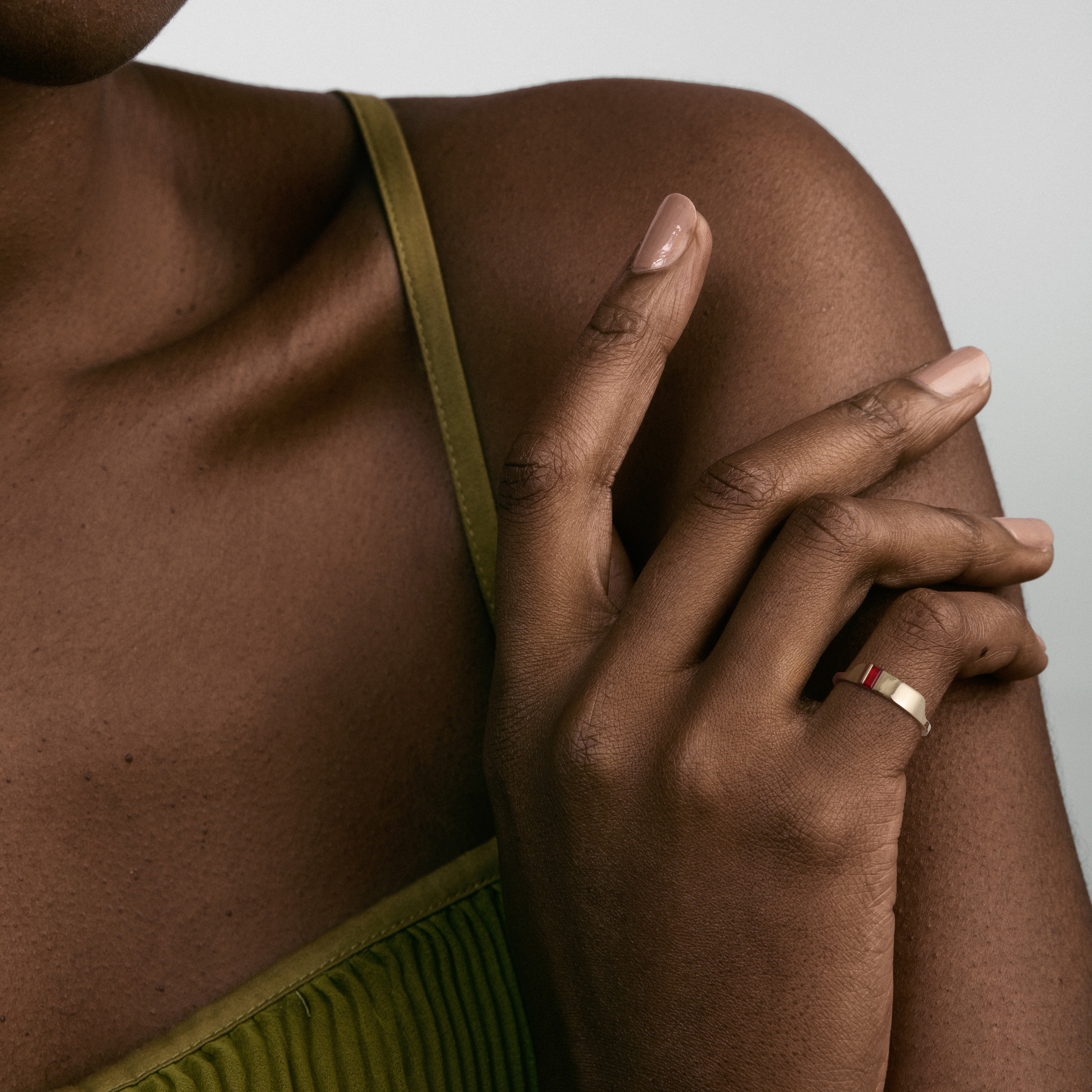 Gold ring with baguette ruby worn on hand