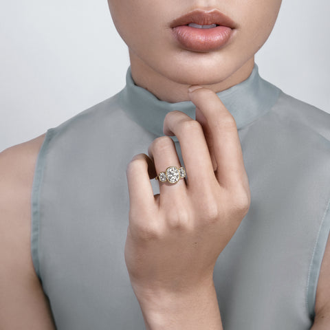 Tyra three elongated cushion diamond engagement ring worn on hand