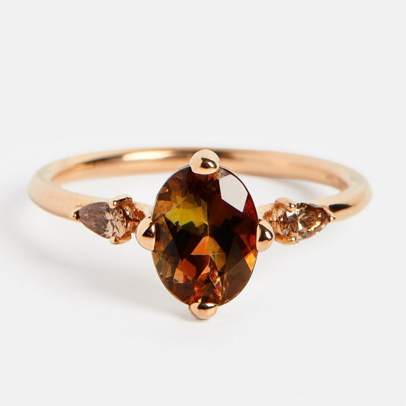 Minimalist stones on side engagement ring with neutral color gemstone and cognac pear cut diamonds in 18k rose gold by SHW jewelry in NYC