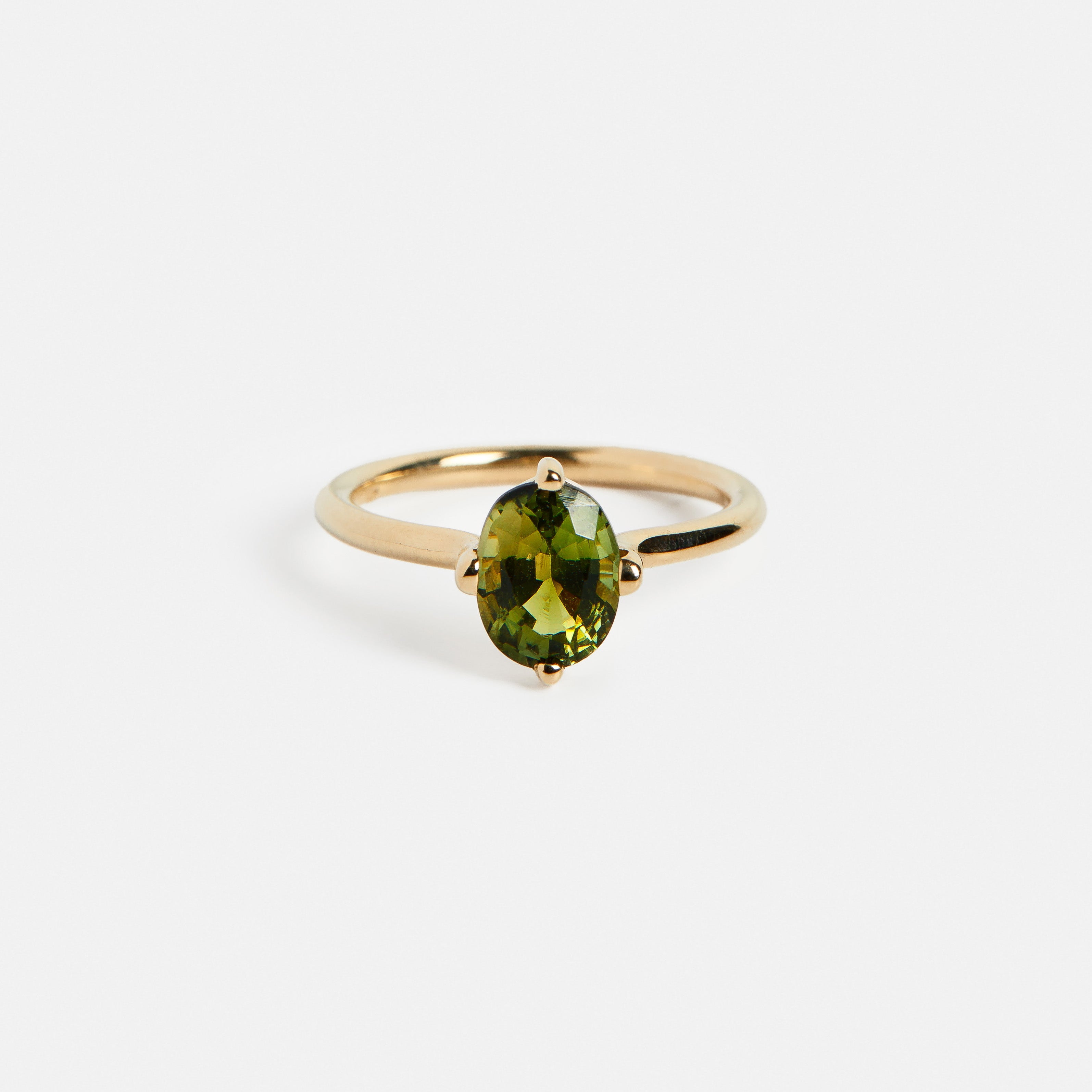 Hooks setting engagement ring with oval 1.5ct grassy green tourmaline gemstone in 14k yellow gold by SHW famous fine jewelry store in NYC