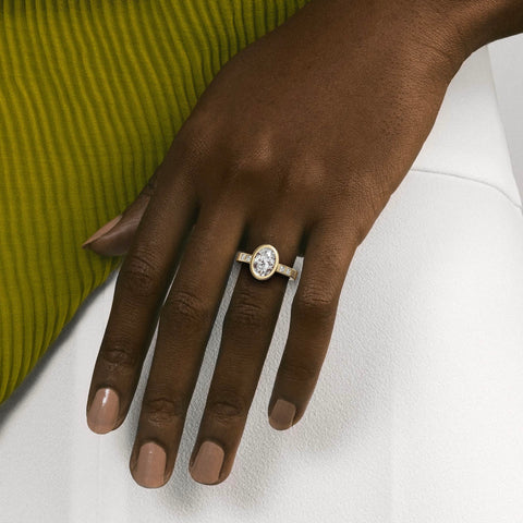 close view of oval diamond engagement ring with princess-cut diamonds flanking the center stone