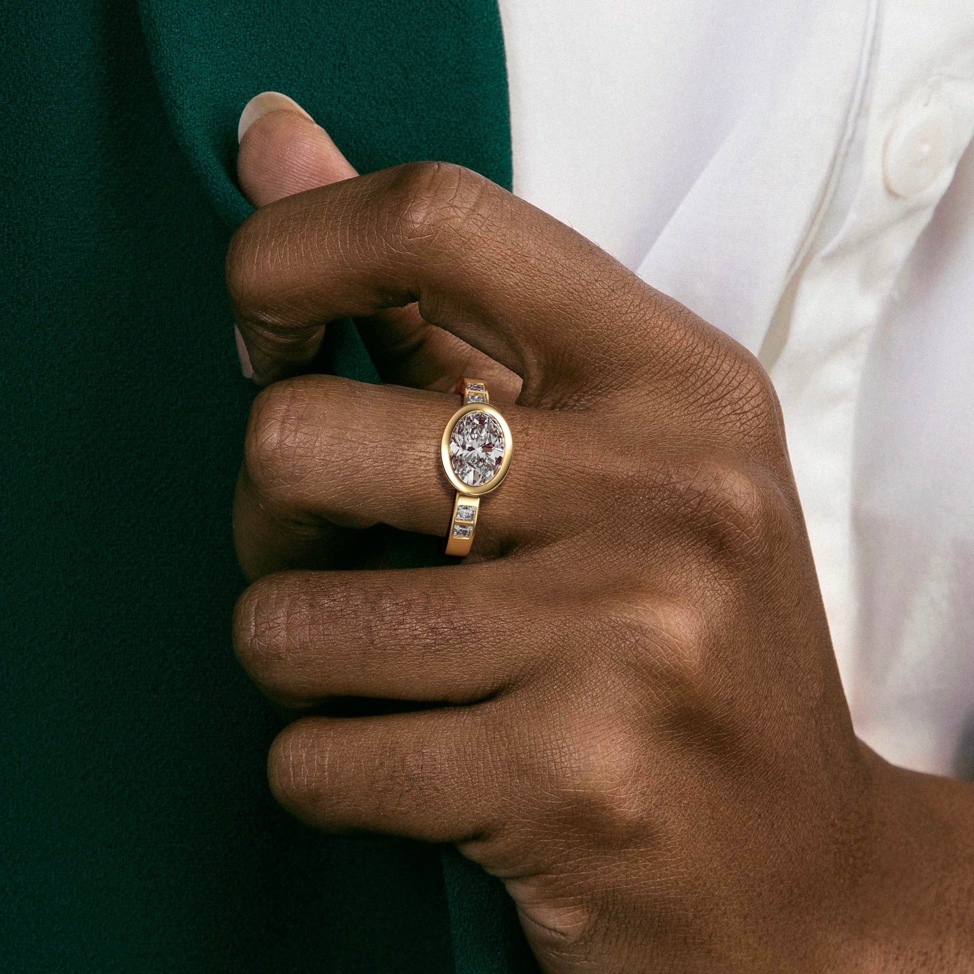 close view of east west oval diamond engagement ring with princess-cut diamonds flanking the center stone