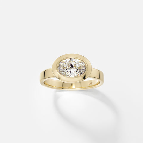 14k yellow gold wide flat band engagement ring with 1 carat east-west oval diamond in thick bezel setting