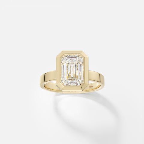 14k yellow gold wide flat band engagement ring with 2.50 carat emerald-cut diamond set north south in thick bezel