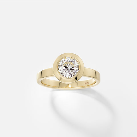 14k yellow gold wide flat band engagement ring with 1 carat round brilliant diamond in thick bezel setting