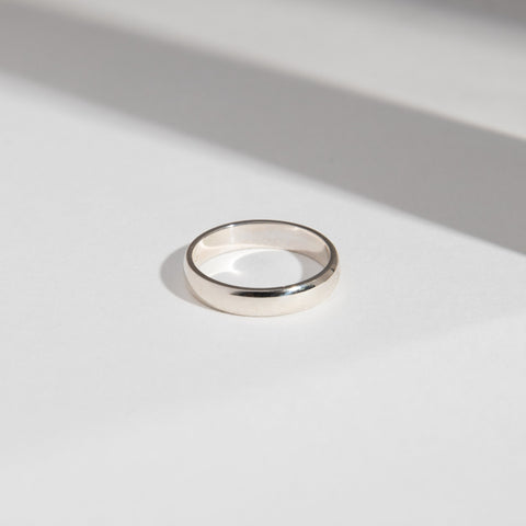 14k white gold 4mm domed wedding band shown in natural light