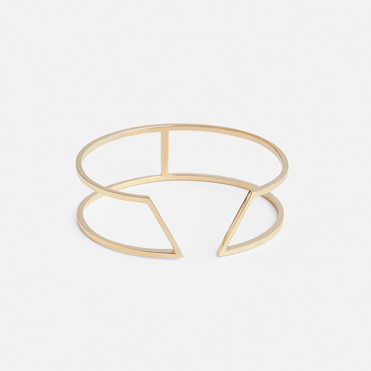 yellow brass bracelet with angular geometric lines and structured modern silhouette