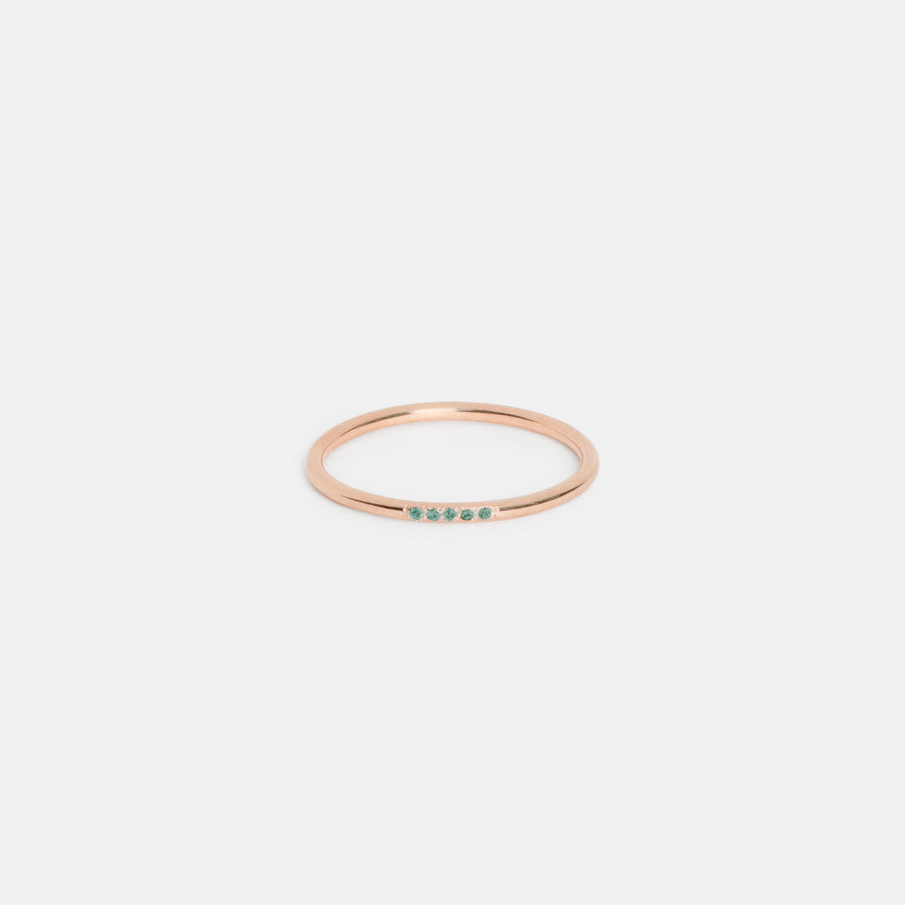 14k rose gold delicate wedding band with five emerald stones
