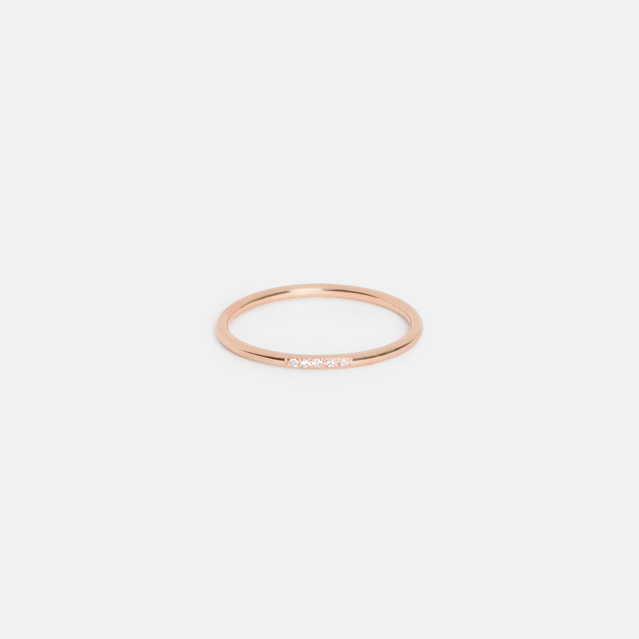14k rose gold delicate band featuring five round white diamonds