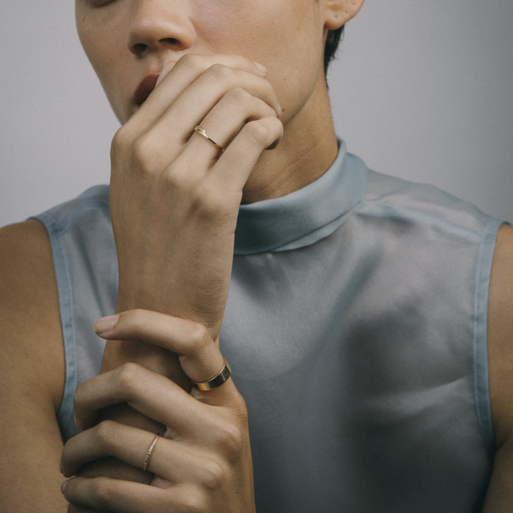 Thin ruby half eternity wedding band worn on hand