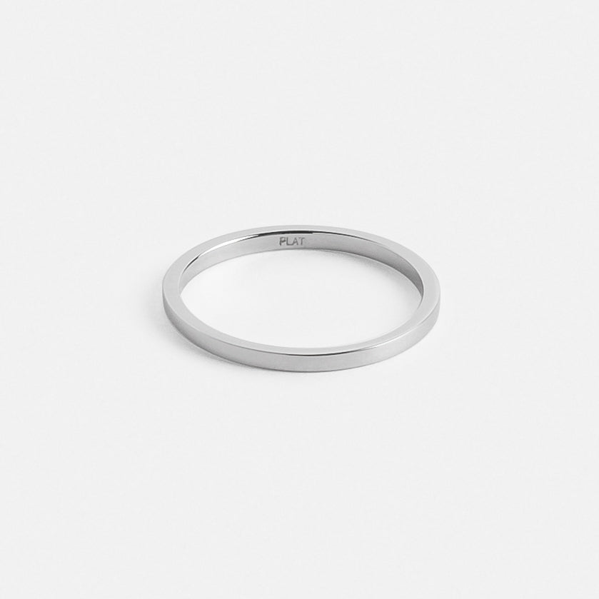 Close view of a slim flat platinum wedding band with clean edges