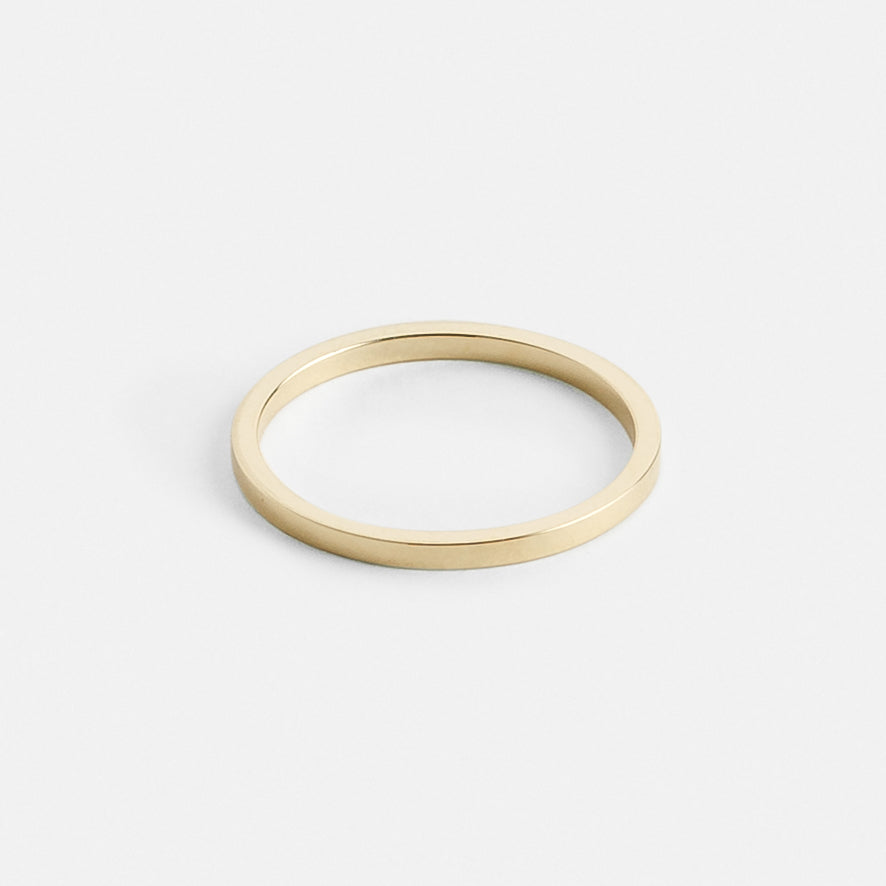 Close view of a slim flat profile gold wedding band