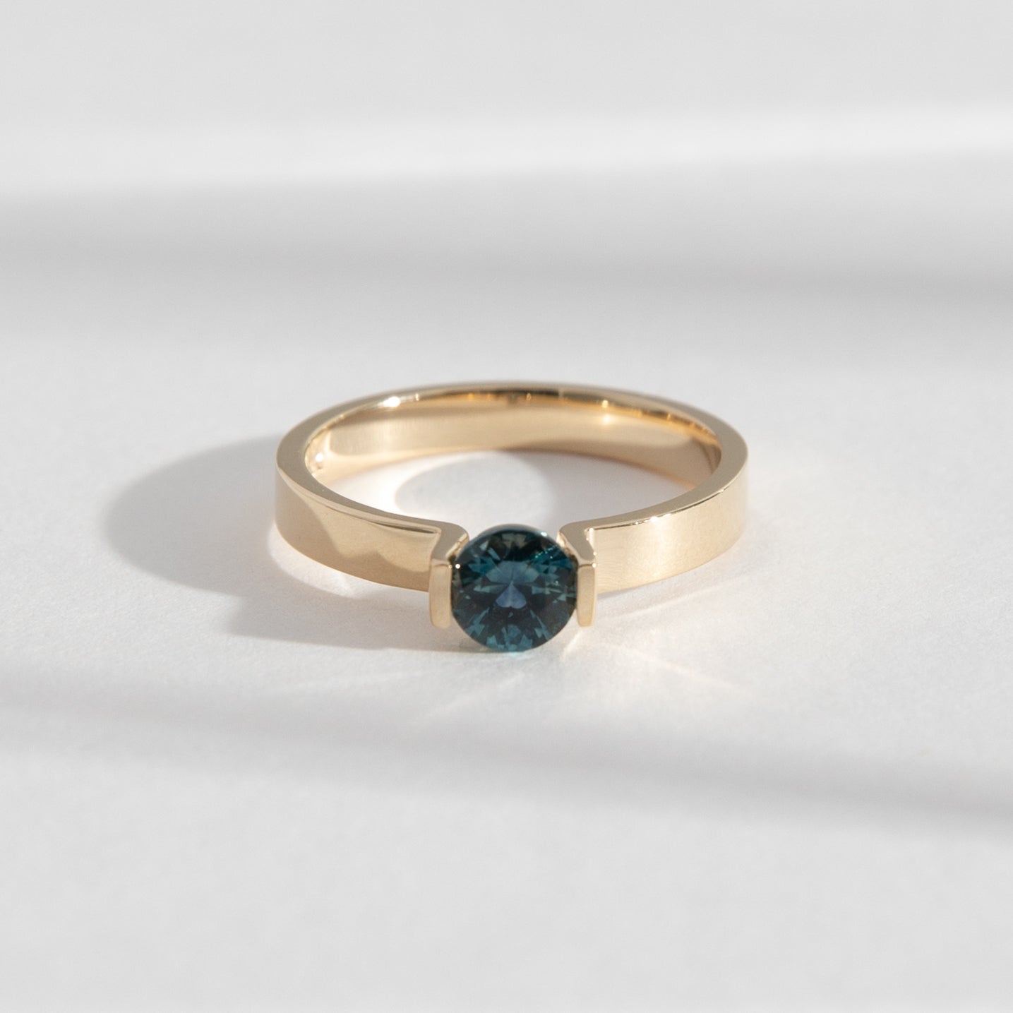 Lara Minimal Ring in 14k Gold set with a 0.59ct round brilliant cut dark teal sapphire By SHW Fine Jewelry NYC