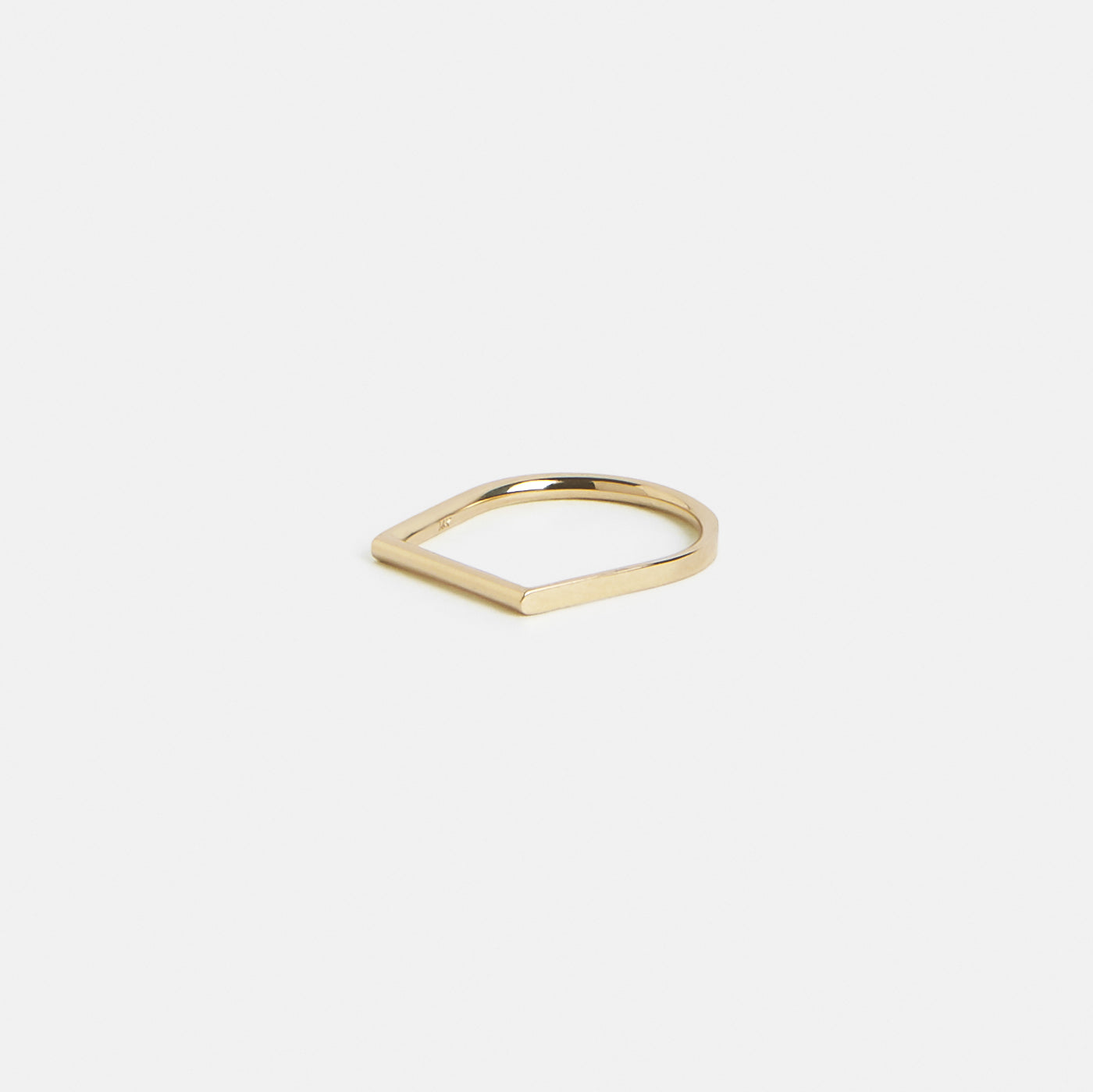 Delicate solid gold band highlighting irregular contour