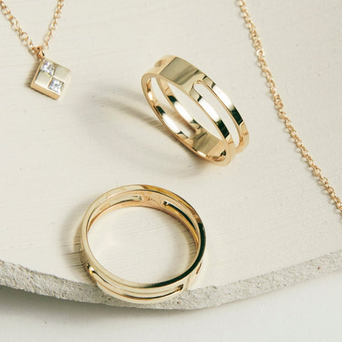 Double band gold rings styled with SHW necklaces in the background