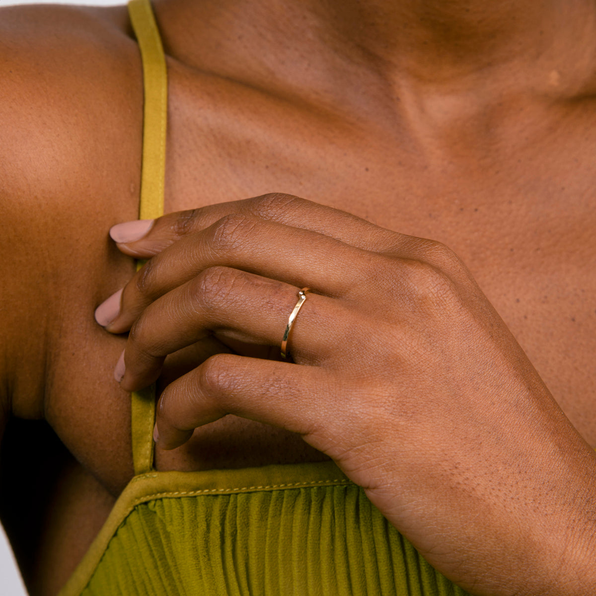 Offset band ring with two black diamonds shown worn on hand