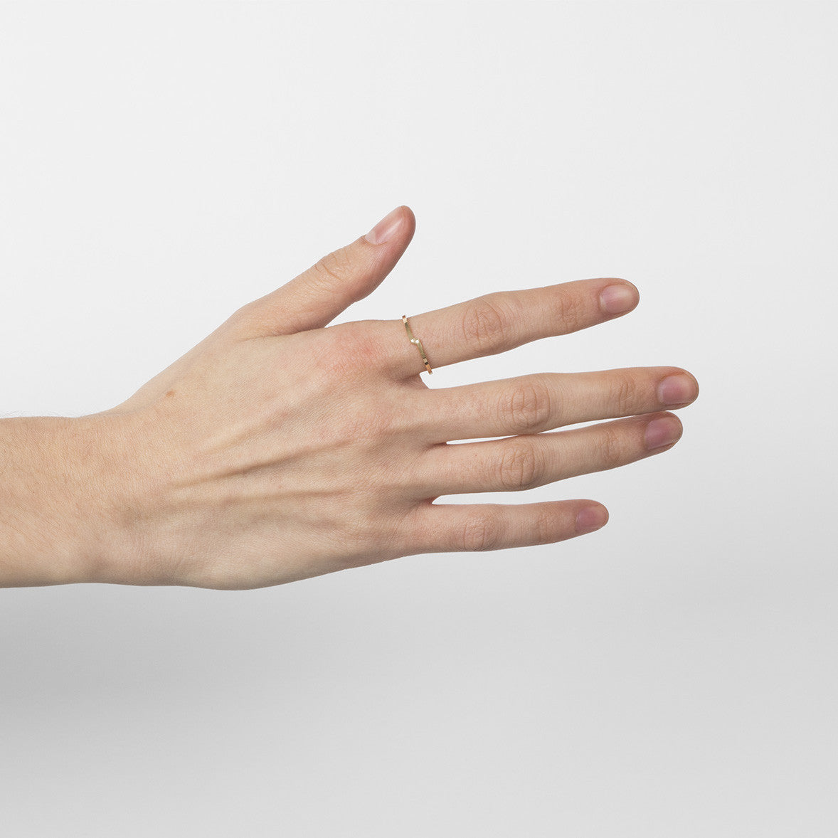 Thin double band ring with two white diamonds worn on hand