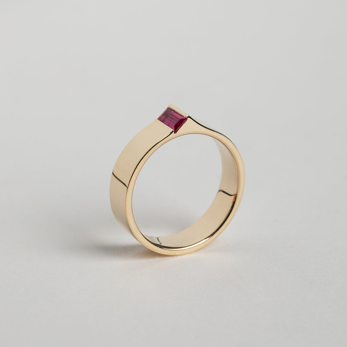 Cool Braga Ring in 14 karat yellow gold set with a baguette cut precious ruby gemstone by SHW Fine Jewelry made in NYC