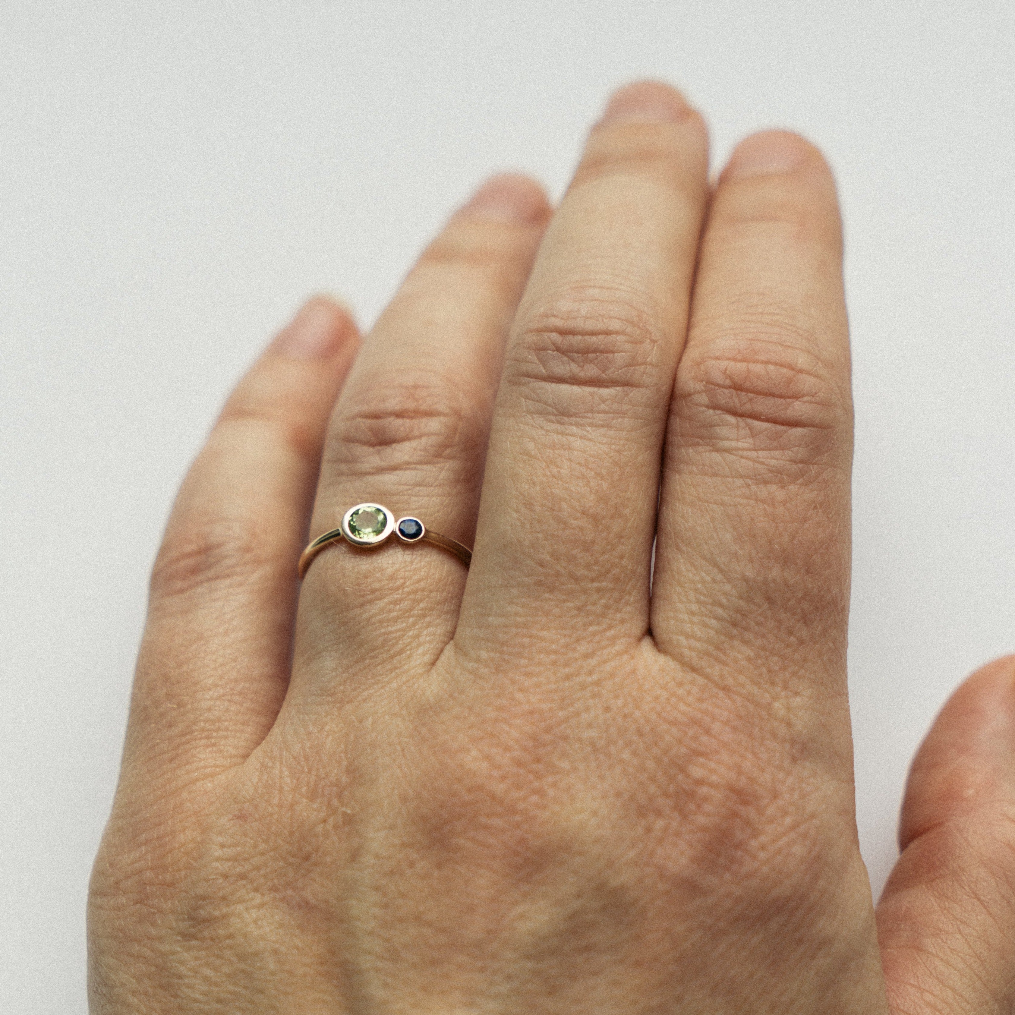 Kiki nontraditional ring in 14k gold set with peridot and sapphire